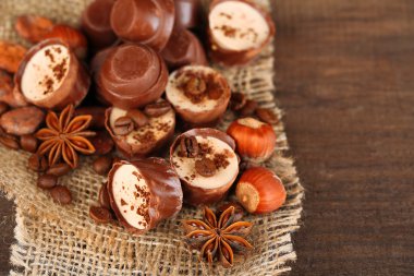 kahve çekirdekleri ve ahşap zemin üzerine fındık ile lezzetli çikolata şekerleme