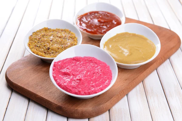 Various sauces on chopping board on table close-up — Stock Photo, Image