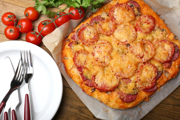 Homemade pizza on baking paper close up