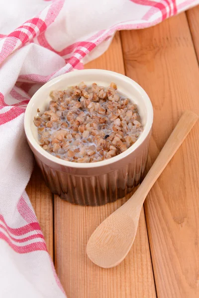 Boiled buckwheat with milk in bowl on table close-up — Stock Photo, Image