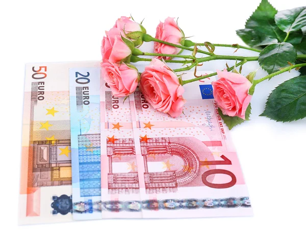 Krásné růže a peníze, izolované na bílém — Stock fotografie