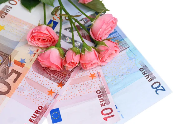 Mooie rozen en geld, geïsoleerd op wit — Stockfoto