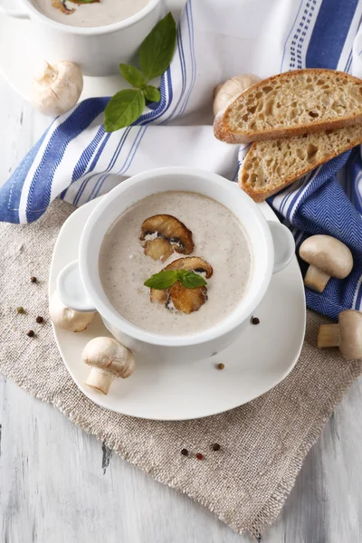 Mushroom soup in white pots, on napkin, on wooden background — Stock Image Mushroom soup in white pots, on napkin, on wooden background Royalty Free Stock Photos