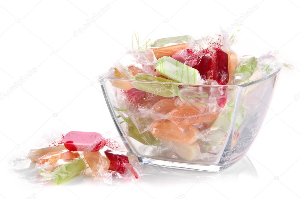 Tasty candies in vase isolated on white