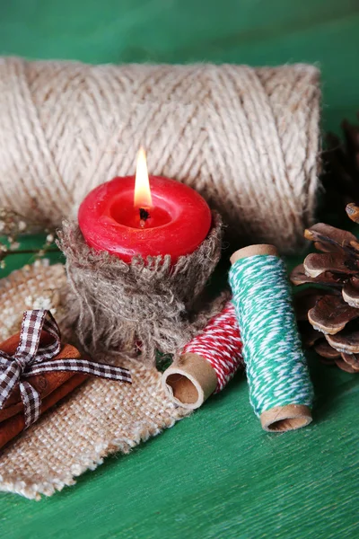 Composition with natural bump, candle, thread, cinnamon sticks on wooden background — Stock Photo, Image
