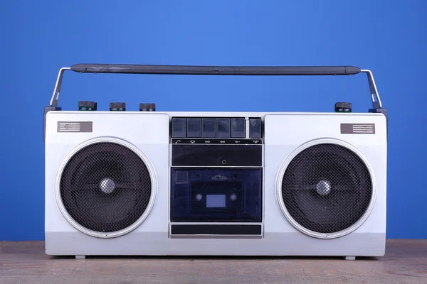 Retro cassette stereo recorder on table on blue background — Stock Photo, Image