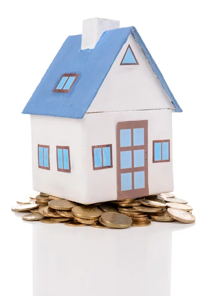 House standing on heap of coins isolated on white — Stock Photo, Image