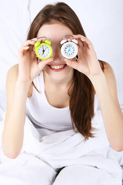 Woman with alarm clocks — Stock Photo, Image