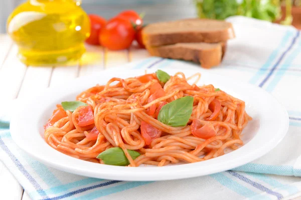 Pasta with tomato sauce on plate on table close-up — Stock Photo, Image
