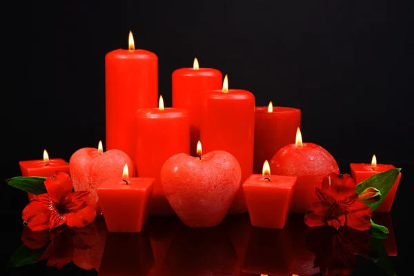 Hermosas velas con flores aisladas en negro —  Fotos de Stock