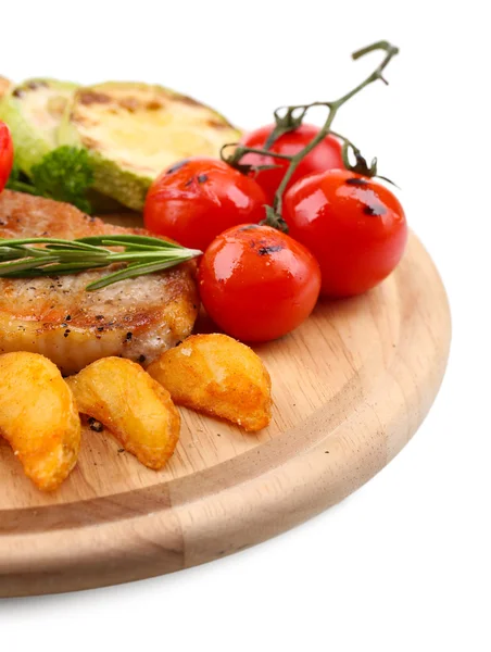 Grilled steak with fried potato pieces and grilled vegetables  on wooden board, isolated on white — Stock Photo, Image