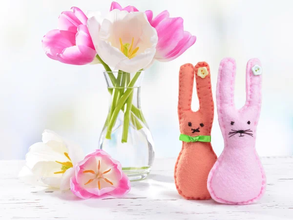 Beautiful tulips in bucket in vase on table on light background — Stock Photo, Image