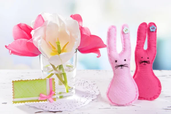 Beautiful tulips in bucket in vase on table on light background — Stock Photo, Image