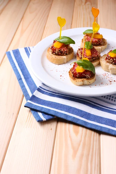 Tasty canapes with salami — Stock Photo, Image