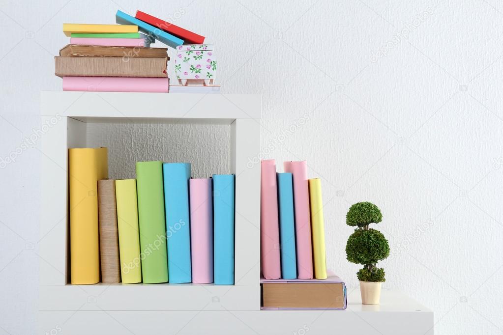 Books on white shelves in room