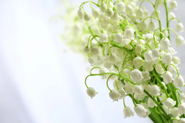 Beautiful lilies of the valley on cloth background — Stock Photo, Image