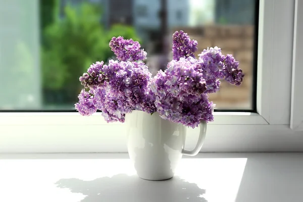 Schöne fliederfarbene Blumen auf der Fensterbank — Stockfoto