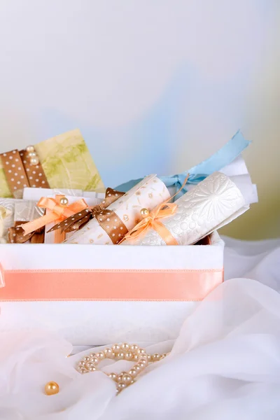 Beautiful handmade wedding cards in box, on light background — Stock Photo, Image