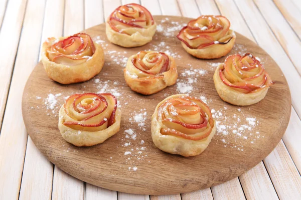 Tasty  puff pastry with apple shaped roses on table close-up — Stock Photo, Image