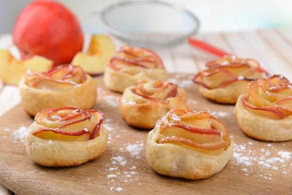 Tasty  puff pastry with apple shaped roses on table close-up — Stock Photo, Image