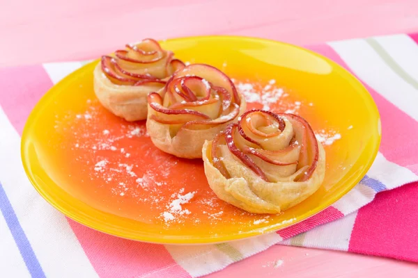 ขนมปังพัฟอร่อยกับดอกกุหลาบรูปแอปเปิ้ลบนจานบนโต๊ะใกล้ชิด — ภาพถ่ายสต็อก