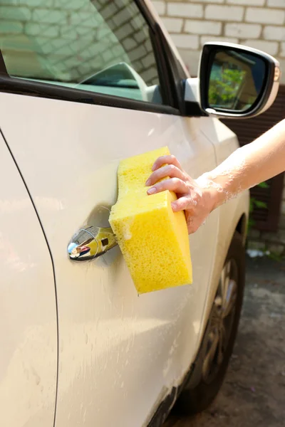 Outdoor car wash with yellow sponge — Stock Photo, Image
