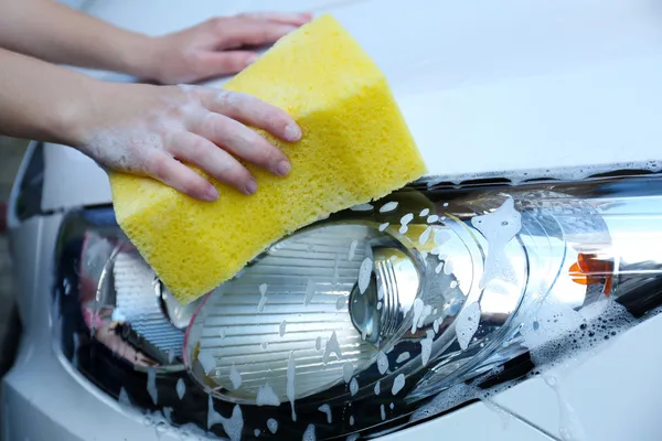 Outdoor car wash with yellow sponge — Stock Photo, Image