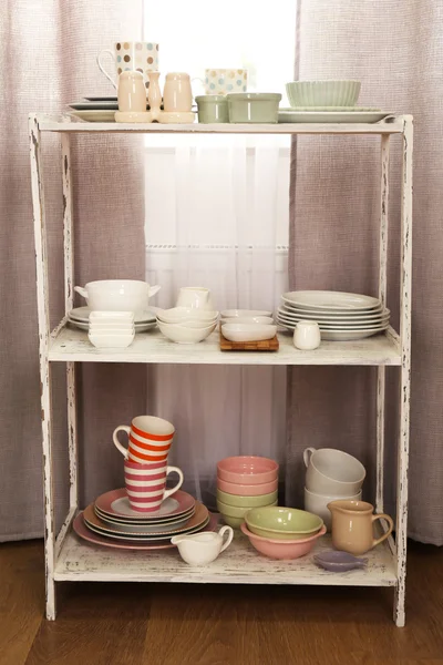 Different tableware on shelf in the interior — Stock Photo, Image