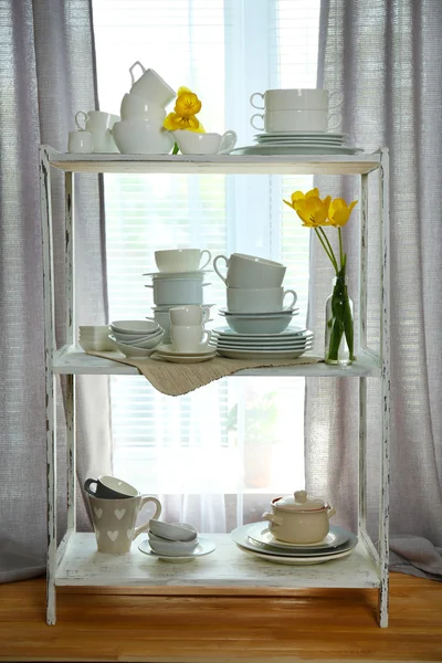 Different tableware on shelf in the interior — Stock Photo, Image