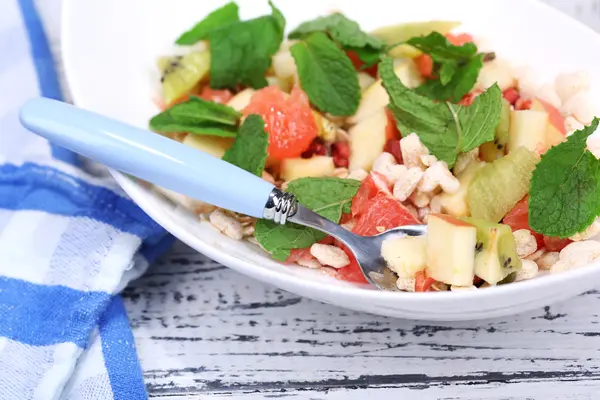 Tasty fruit salad wooden table background — Stock Photo, Image