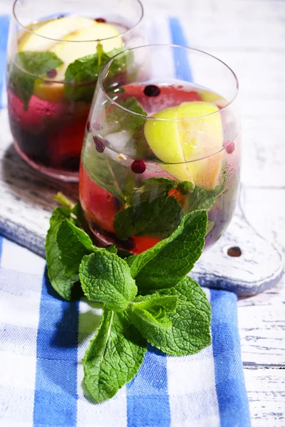 Schmackhafter Cocktail mit frischen Früchten und Minzblättern auf Holztischhintergrund — Stockfoto
