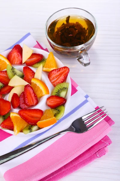 Various sliced fruits on plate on table close-up — Stock Photo, Image