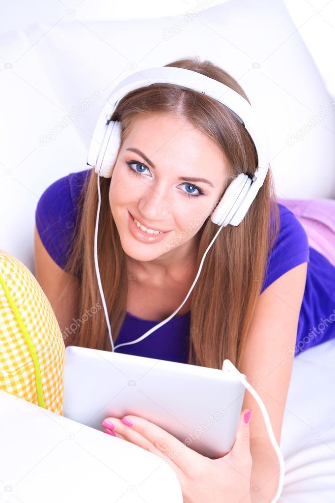 Beautiful girl with PC tablet and headphones.