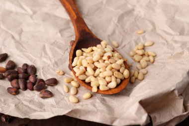Cedar pine nuts in wooden spoon 