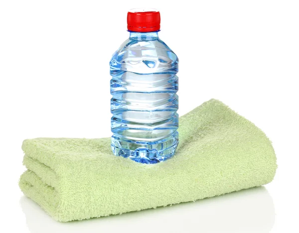 Plastic bottle of water on towel isolated on white — Stock Photo, Image