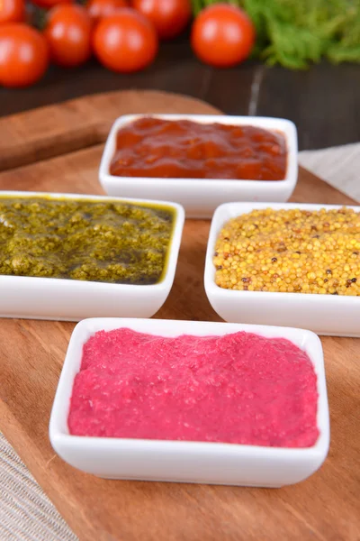 Various sauces on chopping board on table close-up — Stock Photo, Image