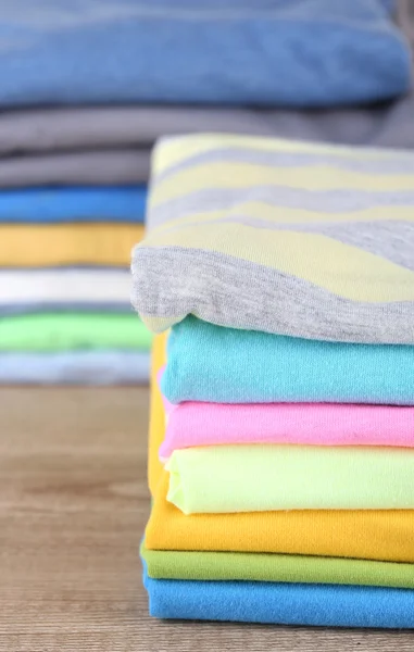 Stack of colorful clothes, on light background — Stock Photo, Image