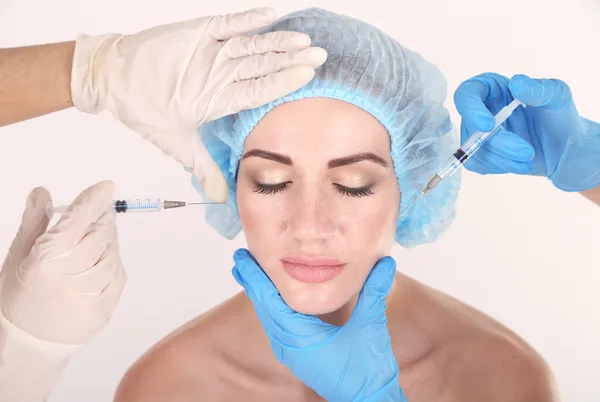 Donna in clinica di bellezza che fa l'iniezione di botox, isolata su bianco — Foto Stock