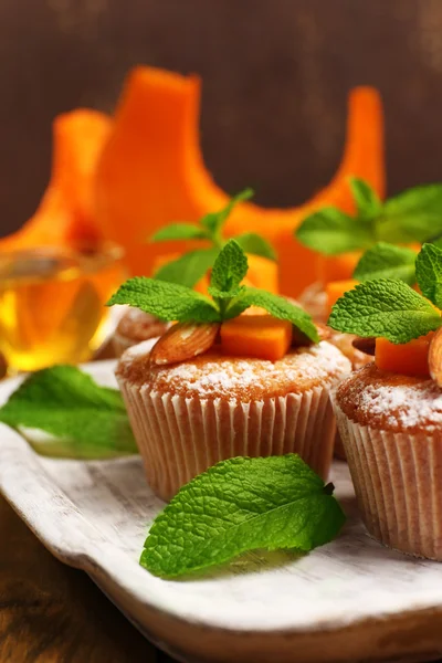 Tasty pumpkin muffins on wooden table — Stock Photo, Image