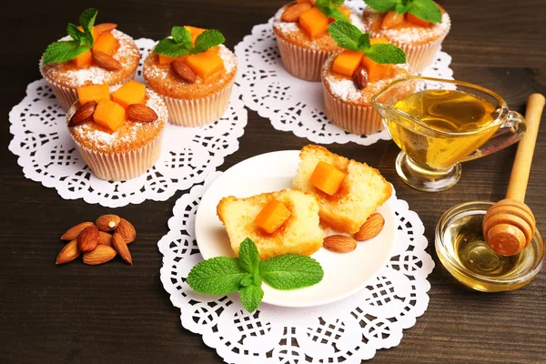 Tasty pumpkin muffins on wooden table — Stock Photo, Image