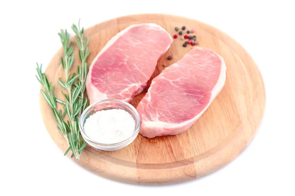 Raw meat steak with herbs and spices on cutting board, isolated on white — Stock Photo, Image