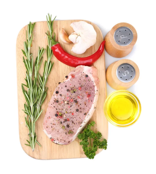 Raw meat steak with herbs and spices on cutting board, isolated on white — Stock Photo, Image