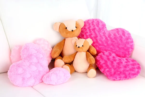 Two bears toy with pillows on sofa — Stock Photo, Image