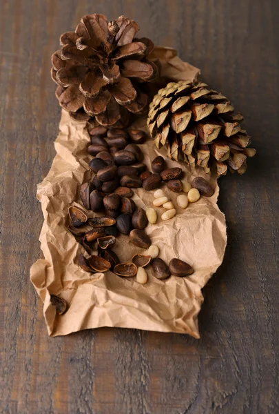 Cedar pine nuts on wooden table — Stock Photo, Image