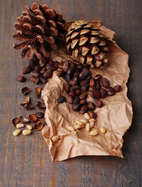 Cedar pine nuts on wooden table — Stock Photo, Image