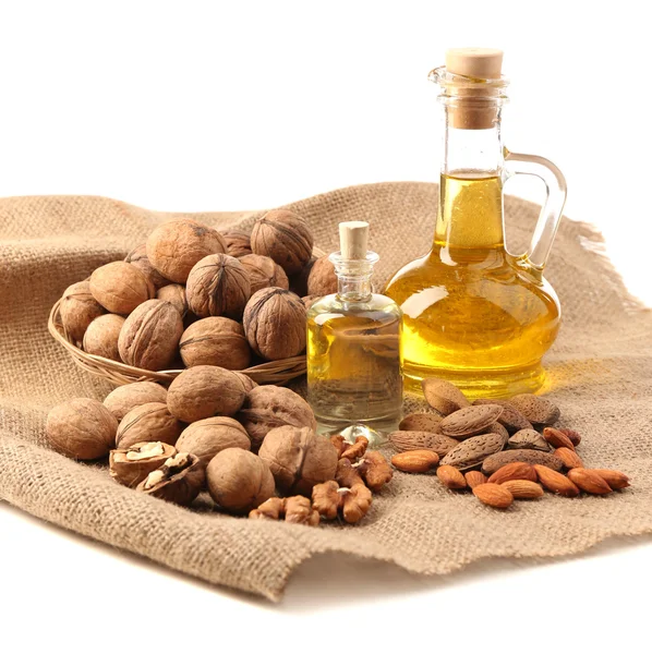 Walnut oil and nuts, isolated on white — Stock Photo, Image