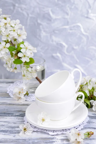 Beautiful fruit blossom in glass on table on grey background — Stock Photo, Image