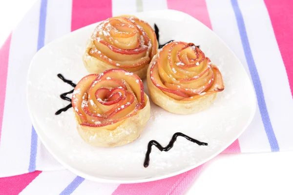 Tasty puff pastry with apple shaped roses on plate close-up — Stock Photo, Image