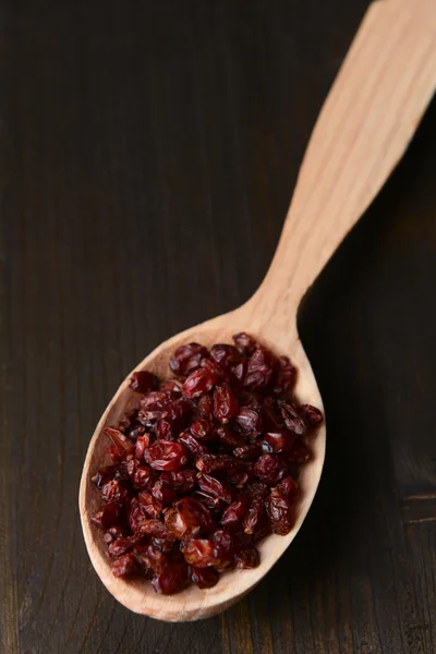 Spice barberry in spoons on wooden background — Stock Photo, Image