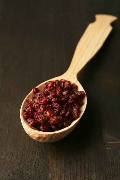 Spice barberry in spoons on wooden background — Stock Photo, Image